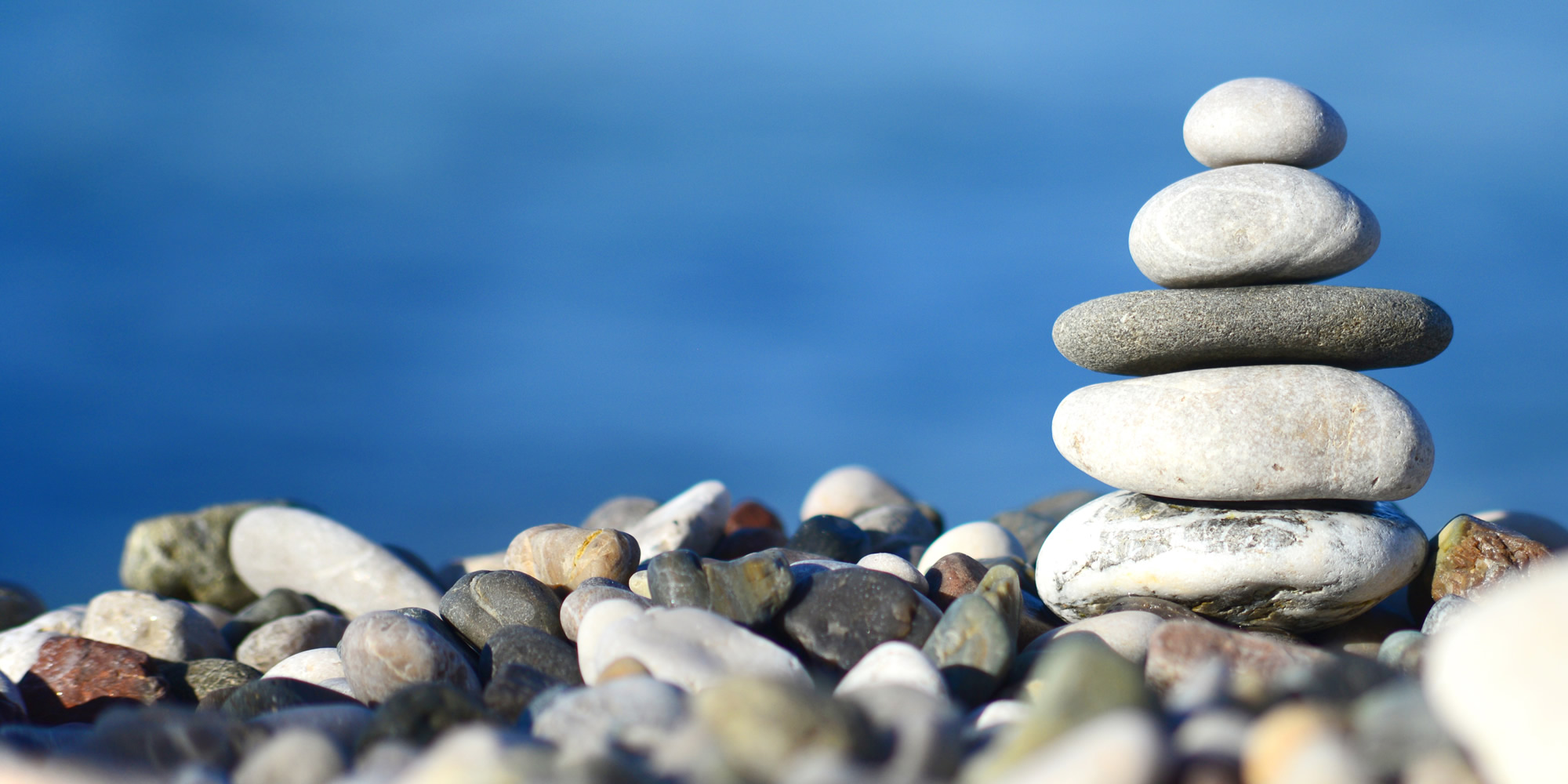 Retreats Hero Image (smooth stones in a Zen-like stacking)