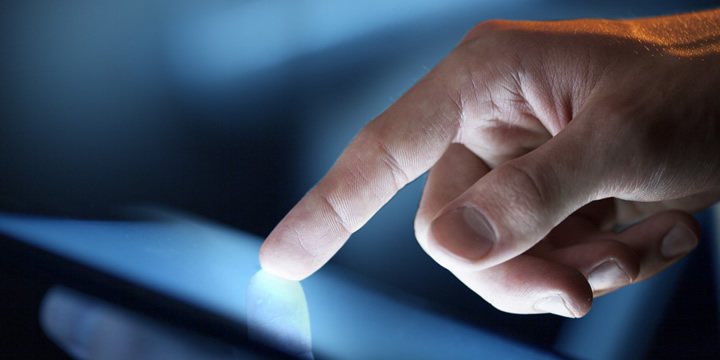 Hand using a tablet.